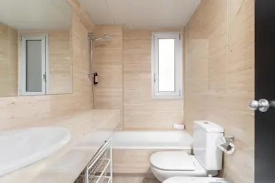 a bathroom with a tub and a toilet and a sink at TSA Sepulveda in Barcelona