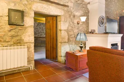 a living room with a couch and a lamp on a table at Sant Marçal del Montseny in Montseny