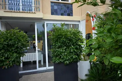 a building with potted plants in front of a building at Beach House in Castelldefels