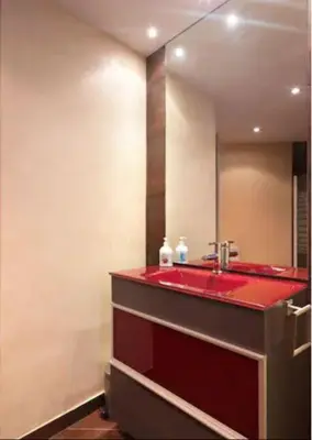 a bathroom with a red sink and a mirror at Lucas House Apartments by Sitges Group in Sitges
