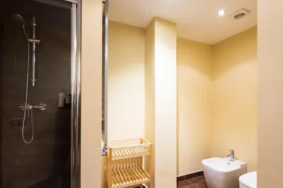 a bathroom with a shower and a toilet and a sink at Lucas House Apartments by Sitges Group in Sitges
