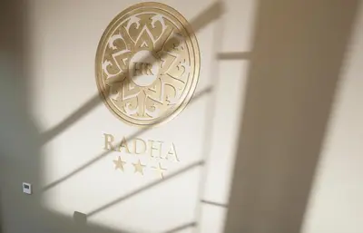 a sign on a building with the raia logo on it at Hotel Radha in Hospitalet de Llobregat