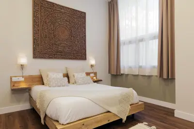 a bedroom with a bed with a picture on the wall at Hotel Radha in Hospitalet de Llobregat