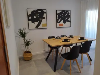 a living room with a black couch and a table at Apartaments IXA in Manresa
