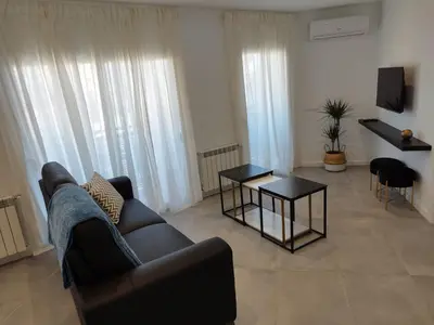 a kitchen with a sink and a clock on the wall at Apartaments IXA in Manresa