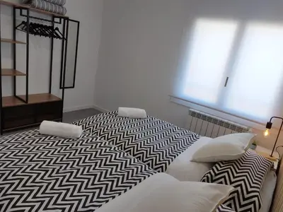 a balcony with a wooden bench and a window at Apartaments IXA in Manresa