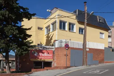 a yellow building on the corner of a street at Mellow Barcelona in Barcelona