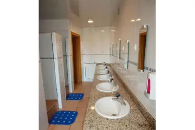 a row of sinks in a public bathroom at Mellow Barcelona in Barcelona