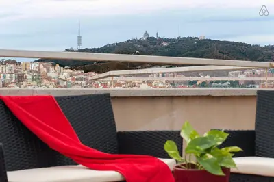 a red scarf on a balcony with a view of a city at Mellow Barcelona in Barcelona