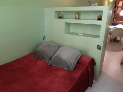 a small bedroom with a bed with a red blanket at Apartaments Sant Jordi Girona 97 in Barcelona