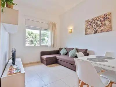 a living room with a couch and a table at Apartamentos Velor in Castelldefels