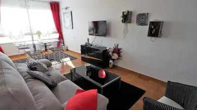 a living room with a couch and a tv at Cristina Port & Beach - Apartment in Masnou