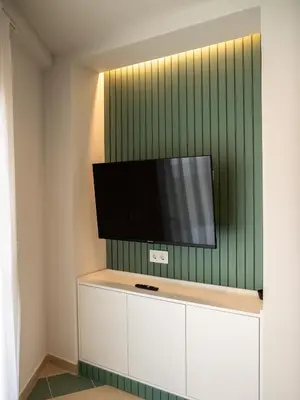 a flat screen tv on a wall in a room at Apartamentos Sunway Atlanta in Sitges