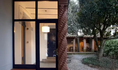 a glass door of a house with a tree at Can Calixto in Aiguafreda