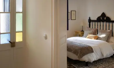 a bedroom with a bed and a window and a door at Can Calixto in Aiguafreda