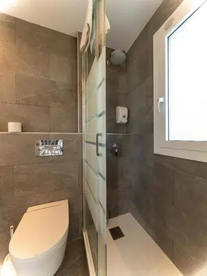 a bathroom with a toilet and a shower at Apartamentos Sunway Apollo in Sitges