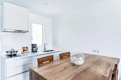 a kitchen with a wooden table with a bowl on it at Apartamentos Sunway Apollo in Sitges