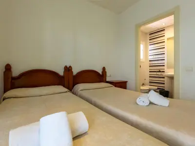 two beds sitting next to each other in a bedroom at Apartamentos Sunway San Jorge in Sitges