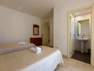 a hotel room with two beds and a sink at Apartamentos Sunway San Jorge in Sitges