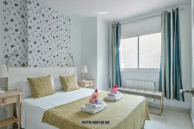 a bedroom with two dolls sitting on a bed at Alcam Rogent in Barcelona