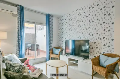 a living room with a couch and a tv at Alcam Rogent in Barcelona