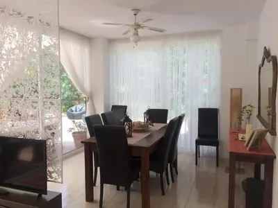 a dining room with a table and chairs at Villa Rosa Sitges in Can Trabal