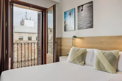 a bedroom with a bed and a large window at Ola Living Boqueria in Barcelona