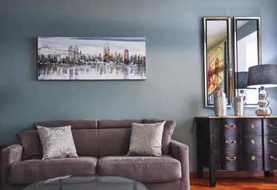 a living room with a couch and a painting on the wall at Alcam Plaza Cataluña in Barcelona