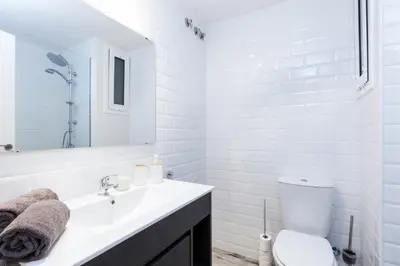 a white bathroom with a sink and a toilet at Vilasarmarlux II in Vilassar de Mar