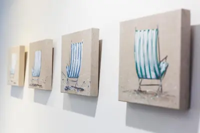 a row of paper boxes with a blue chair in them at Vilasarmarlux II in Vilassar de Mar