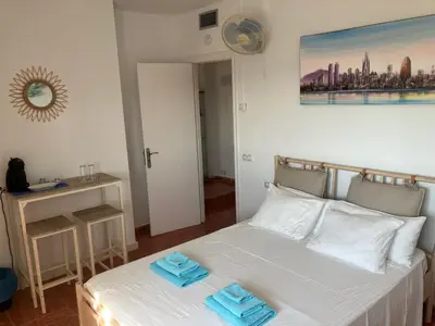 a bedroom with a bed with two towels on it at Casa Mallarenga Rooms in Olivella