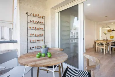 a dining room with a table with green apples on it at Sitges Colonial - al lado de la playa in Sitges