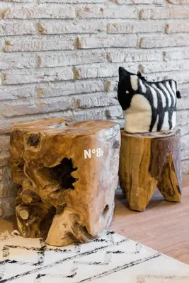 a black and white cat sitting on top of a wooden stump at Sitges Colonial - al lado de la playa in Sitges