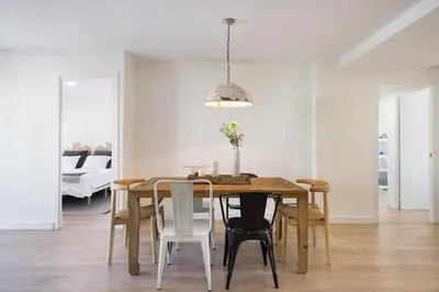 a dining room with a wooden table and chairs at Sitges Colonial - al lado de la playa in Sitges