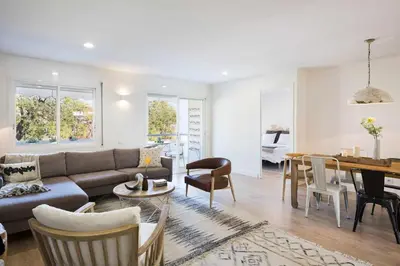 a living room with a couch and a table at Sitges Colonial - al lado de la playa in Sitges