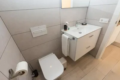 a small bathroom with a toilet and a sink at Rambla de Marisol Apartments in Castelldefels