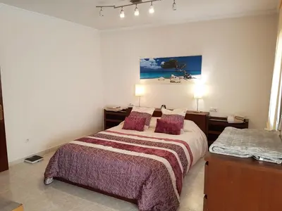 a bedroom with a large bed with purple sheets and pillows at Vil·la La Garriga Termal Congost in La Garriga