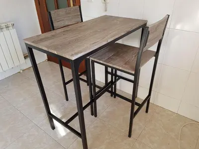 a wooden table with two chairs and a table and a table and a table at Vil·la La Garriga Termal Congost in La Garriga