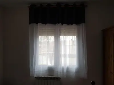 a window with white curtains in a room at Vil·la La Garriga Termal Congost in La Garriga