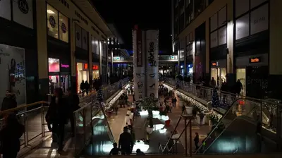 a shopping mall at night with people walking through it at Good-Apartments Barcelona in Barcelona