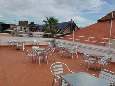 a group of tables and chairs on a roof at La Terrassa in Barcelona