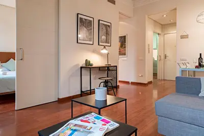 a living room with a couch and a table at Habitat Apartments Paseo de Gracia Suite in Barcelona