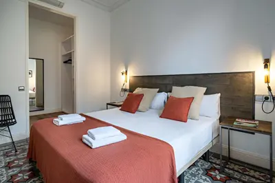 a bedroom with a large bed with two towels on it at Habitat Apartments Eixample Balconies. in Barcelona