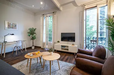 a living room with a couch and a table at Habitat Apartments Eixample Balconies. in Barcelona