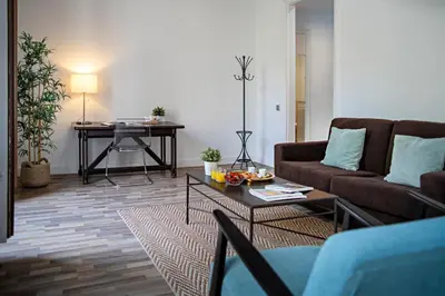 a living room with a couch and a table at Habitat Apartments Eixample Balconies. in Barcelona
