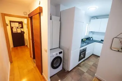 a kitchen with a washer and dryer in a room at RentBCN Park Guell in Barcelona