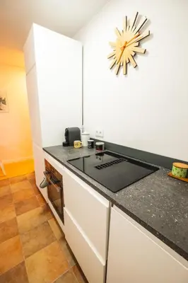 a kitchen with a counter top and a stove at RentBCN Park Guell in Barcelona