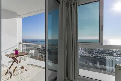 a view from the balcony of a apartment with a table and chairs at 1410 - Mediterranean Forum Apartment in Barcelona