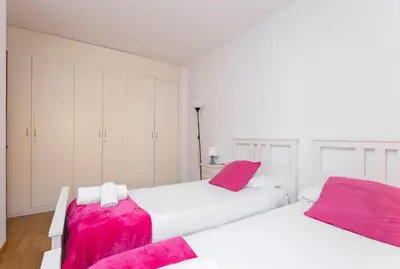 two beds in a white room with pink sheets at 1324 - OLYMPIC DELUXE in Barcelona