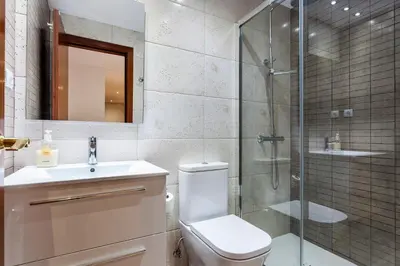 a bathroom with a toilet and a glass shower at 1324 - OLYMPIC DELUXE in Barcelona